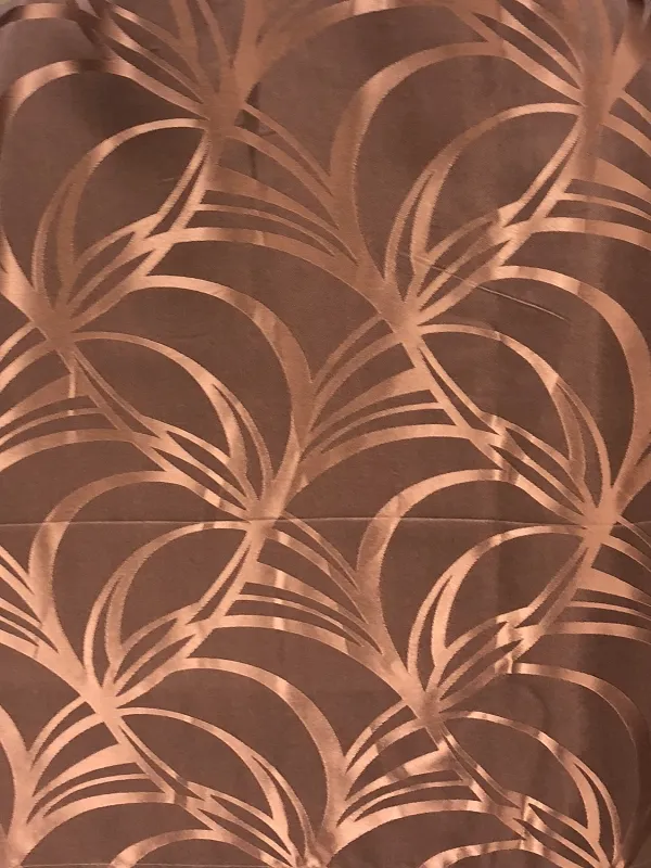 Copperleaf Whisper Sheer curtains with delicate leaf patterns, softly draped in natural light, creating a warm, airy ambiance in a modern living space.