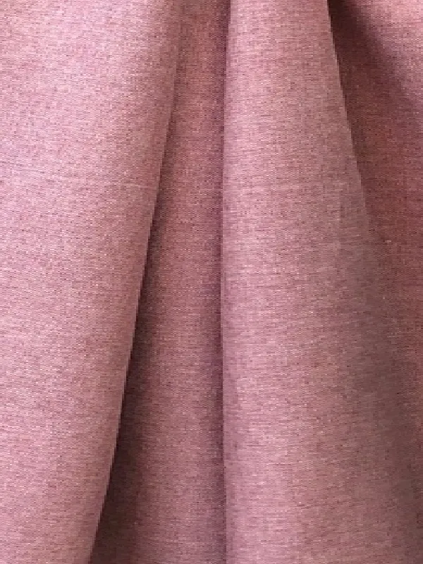 Soft, textured linen curtain in dusty rose hue, gently draped with natural folds, filtering warm daylight in a serene modern living room setting.