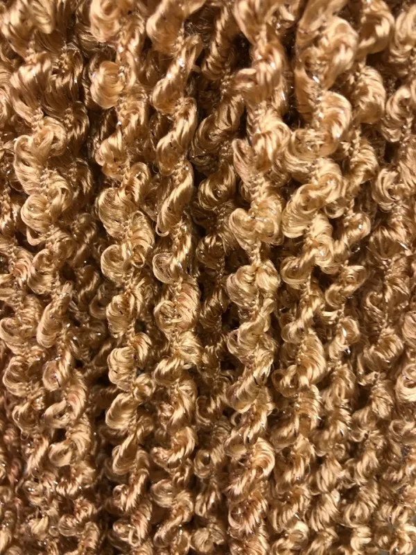 Golden string curtains with shimmering curls, flowing gently in soft sunlight, creating a luxurious and dreamy atmosphere for modern interiors.