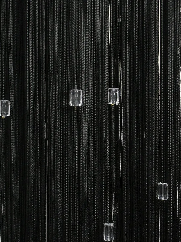 Midnight velvet thread curtain with crystal beads, flowing gracefully in soft light, creating a luxurious and dramatic window treatment for modern interiors.