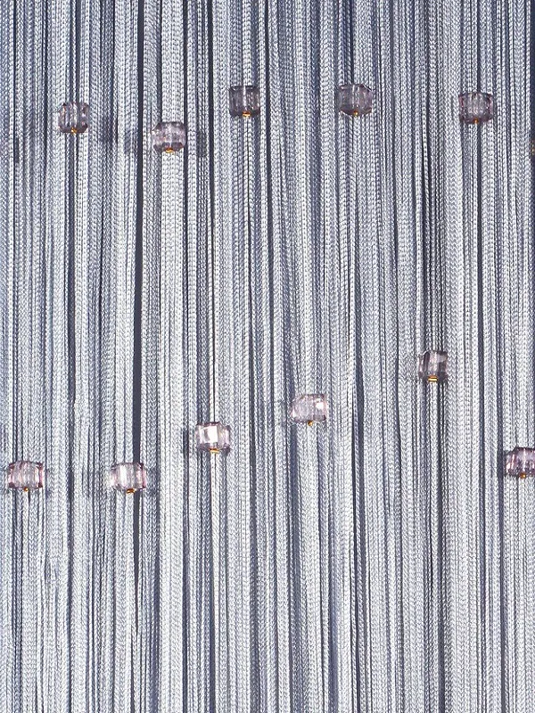 Silver string curtain with dangling crystal orbs, softly diffusing light in a modern room, creating a celestial, dreamy ambiance.