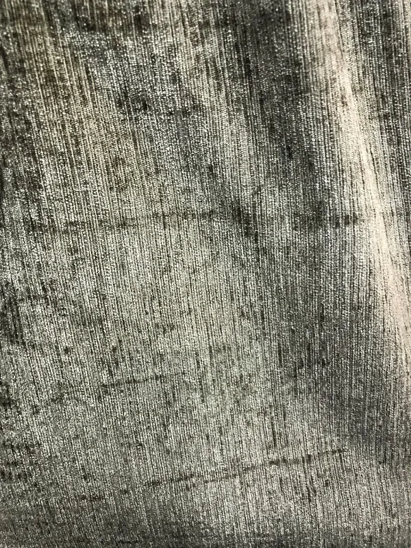 Luxurious velvet curtains with deep, textured pile, softly draped in moonlit tones, creating an elegant, cozy ambiance in a modern living room.