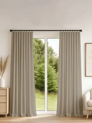Elegant tape-mounted curtains in warm oak tones frame a glass door to a lush green garden, creating a serene, modern living space with natural light and soft drape.